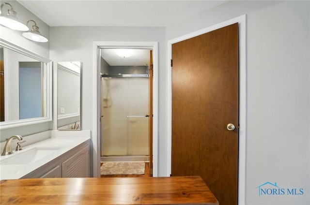 full bathroom featuring vanity and a stall shower