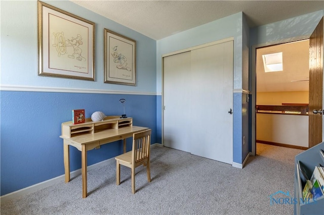 carpeted office space featuring baseboards