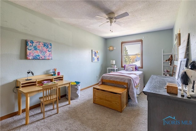 carpeted bedroom featuring a textured ceiling, a ceiling fan, and baseboards