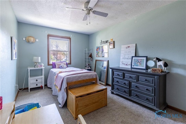 bedroom featuring a textured ceiling, a ceiling fan, baseboards, and light carpet