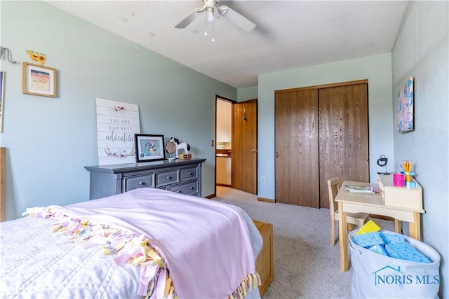 bedroom featuring ceiling fan, a closet, and carpet