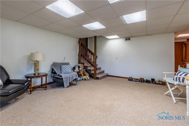 sitting room with stairway, visible vents, a drop ceiling, and carpet floors