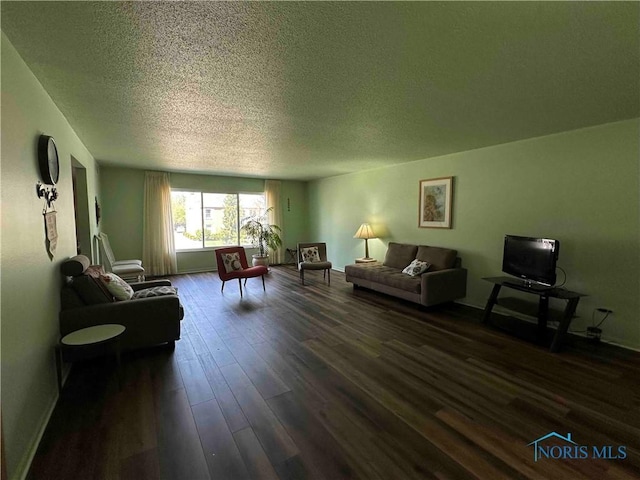 living room featuring baseboards, a textured ceiling, and dark wood-style flooring