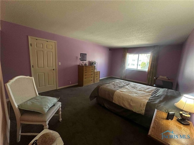 bedroom featuring a textured ceiling, carpet, and baseboards