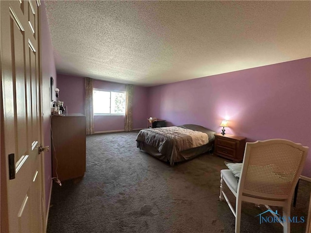 carpeted bedroom with a textured ceiling