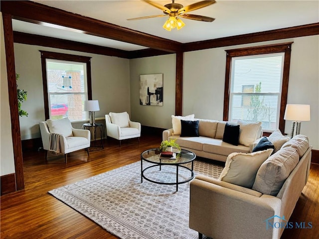 living area with wood finished floors, ceiling fan, and baseboards