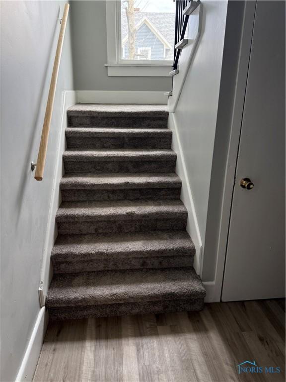 staircase with wood finished floors