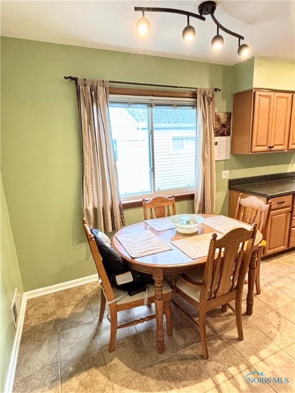 dining space featuring baseboards and visible vents