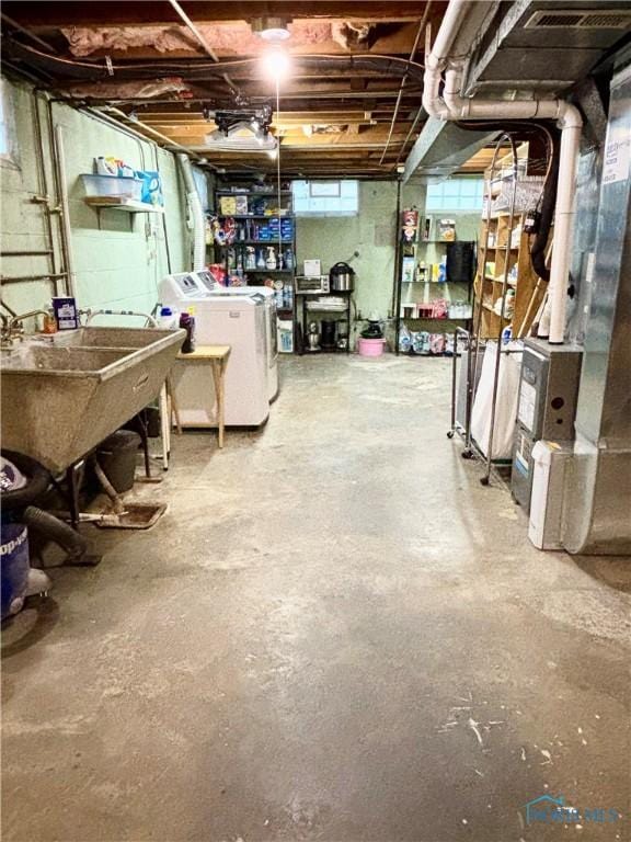 below grade area with independent washer and dryer and a sink