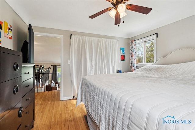 24203 W Reservation Line Rd, Curtice, OH 43412 - bedroom with baseboards, ceiling fan, and light wood finished floors