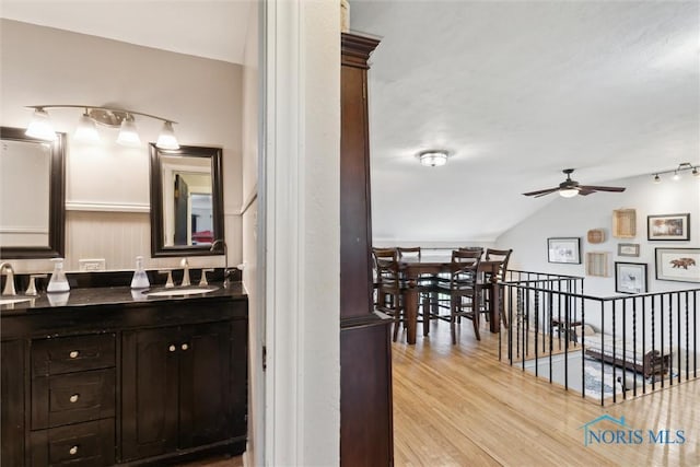 24203 W Reservation Line Rd, Curtice, OH 43412 - bathroom with ceiling fan, a sink, double vanity, wood finished floors, and lofted ceiling