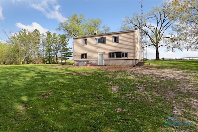 24203 W Reservation Line Rd, Curtice, OH 43412 - rear view of house featuring a yard and a chimney