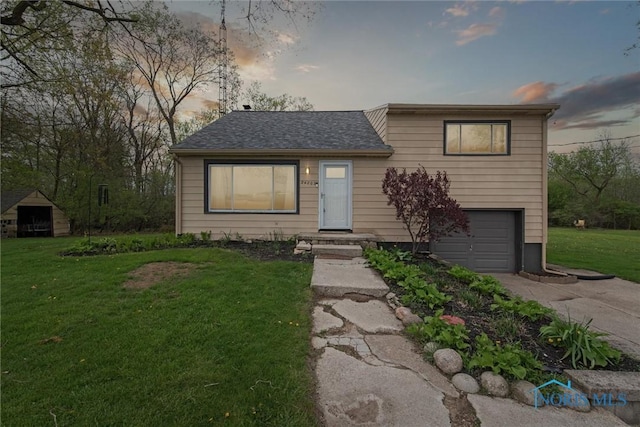 24203 W Reservation Line Rd, Curtice, OH 43412 - view of front of house featuring a garage, a yard, concrete driveway, and roof with shingles