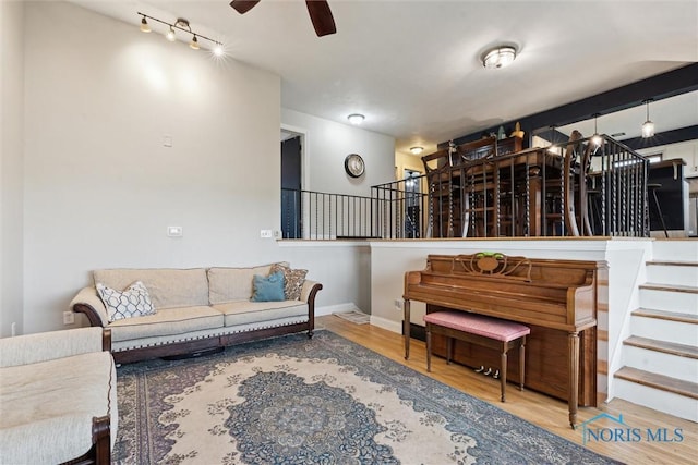 24203 W Reservation Line Rd, Curtice, OH 43412 - living room with baseboards, ceiling fan, wood finished floors, and stairway