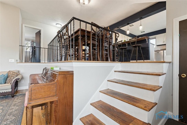 24203 W Reservation Line Rd, Curtice, OH 43412 - stairway with baseboards, wood finished floors, and a wealth of natural light