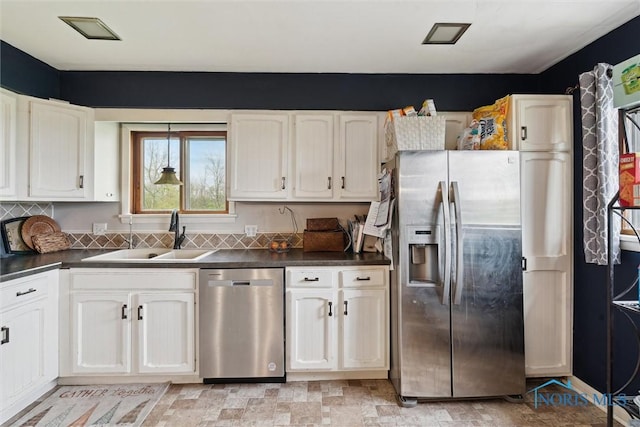 24203 W Reservation Line Rd, Curtice, OH 43412 - kitchen featuring a sink, appliances with stainless steel finishes, white cabinets, and dark countertops