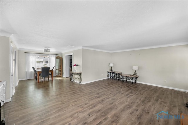 living area featuring crown molding, wood finished floors, and baseboards