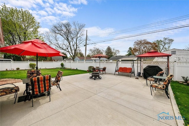 view of patio with a gazebo, an outdoor fire pit, and a fenced backyard