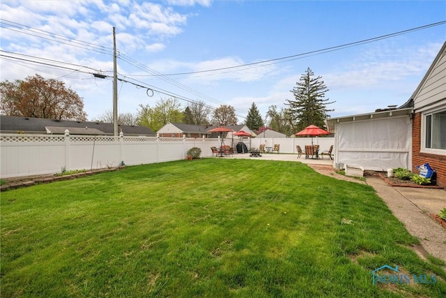view of yard with a patio and a fenced backyard