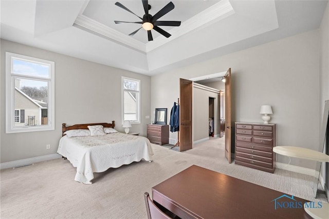 10915 Reed Rd, Monclova, OH 43542 - bedroom with visible vents, a tray ceiling, baseboards, light carpet, and a ceiling fan