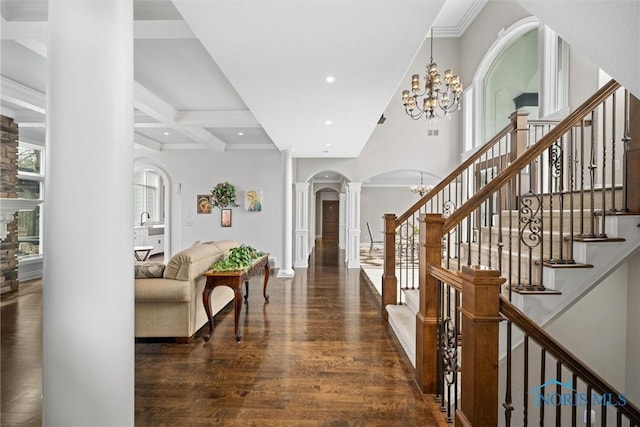 10915 Reed Rd, Monclova, OH 43542 - foyer featuring recessed lighting, arched walkways, wood finished floors, a chandelier, and ornate columns
