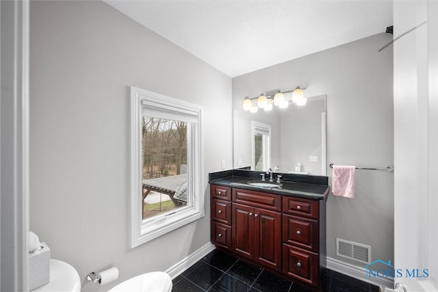 10915 Reed Rd, Monclova, OH 43542 - bathroom featuring toilet, visible vents, vanity, and baseboards