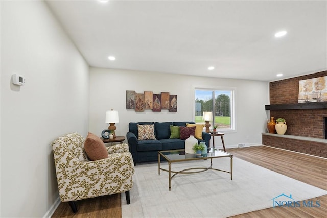 living room with baseboards, recessed lighting, and wood finished floors