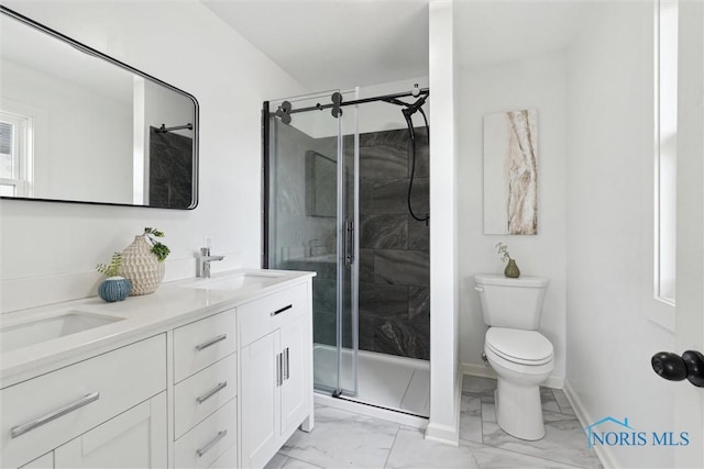 full bathroom featuring a sink, toilet, a stall shower, marble finish floor, and double vanity