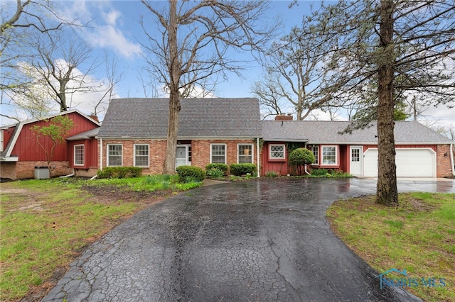 19788 Otsego Pike, Bowling Green, OH 43402 - ranch-style house featuring a shingled roof, a chimney, aphalt driveway, brick siding, and an attached garage