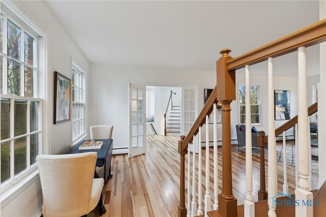 19788 Otsego Pike, Bowling Green, OH 43402 - stairway featuring hardwood / wood-style flooring, french doors, and a baseboard radiator