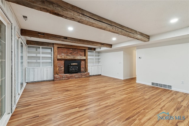 19788 Otsego Pike, Bowling Green, OH 43402 - unfurnished living room with light wood finished floors, visible vents, beam ceiling, and baseboards