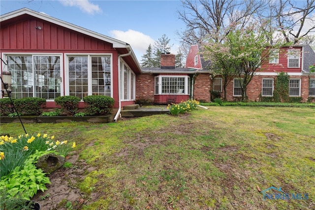 19788 Otsego Pike, Bowling Green, OH 43402 - view of front facade featuring a chimney, brick siding, and a front yard
