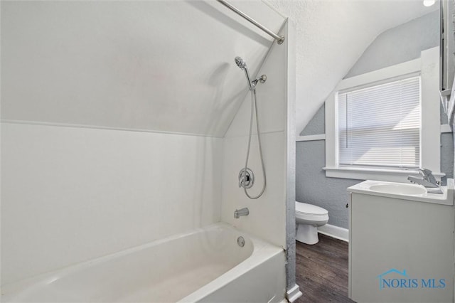 full bath featuring lofted ceiling, toilet, shower / washtub combination, wood finished floors, and vanity