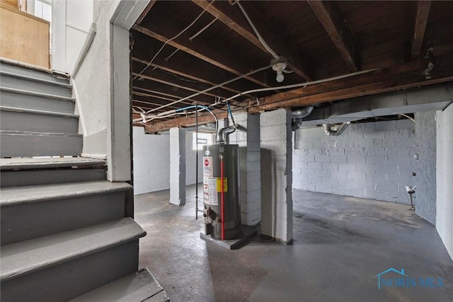 unfinished basement with stairway and gas water heater