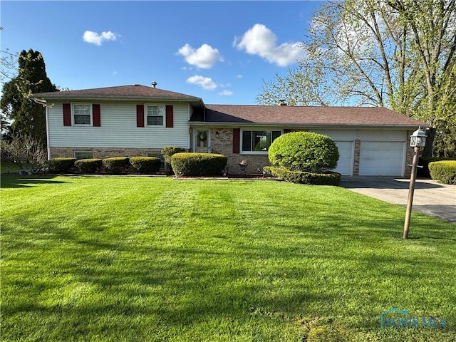 1883 Riverview Dr, Defiance, OH 43512 - split level home with brick siding, a garage, a front lawn, and concrete driveway