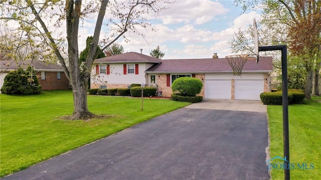 1883 Riverview Dr, Defiance, OH 43512 - tri-level home with an attached garage, a front yard, brick siding, and aphalt driveway