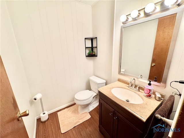 1883 Riverview Dr, Defiance, OH 43512 - bathroom featuring vanity, baseboards, wood finished floors, and toilet
