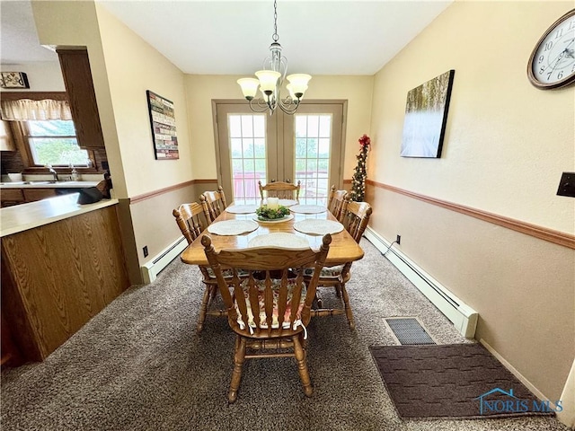 1883 Riverview Dr, Defiance, OH 43512 - dining area with baseboards, an inviting chandelier, and a baseboard radiator