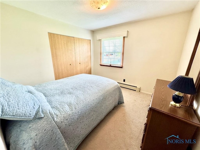 1883 Riverview Dr, Defiance, OH 43512 - carpeted bedroom with a baseboard radiator and a closet