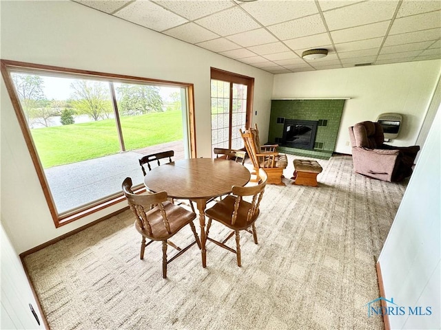 1883 Riverview Dr, Defiance, OH 43512 - dining space with carpet flooring, a water view, a glass covered fireplace, and a drop ceiling
