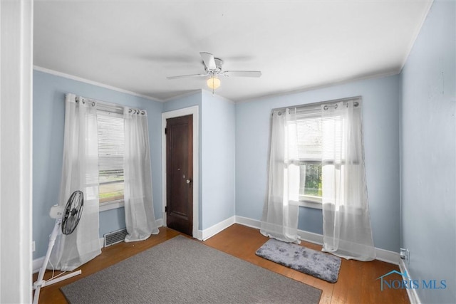 4532 290th St, Toledo, OH 43611 - unfurnished room featuring ceiling fan, baseboards, crown molding, and wood finished floors