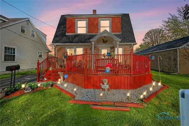 4532 290th St, Toledo, OH 43611 - back of house with brick siding, roof with shingles, a yard, and a deck