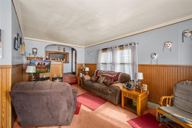 4532 290th St, Toledo, OH 43611 - carpeted living area with a wainscoted wall, wood walls, ornamental molding, and arched walkways