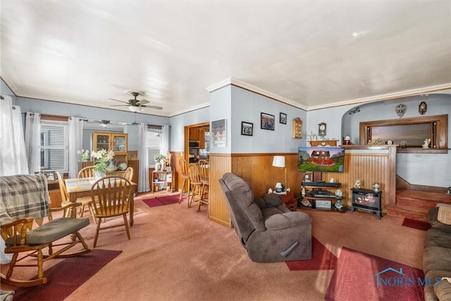 4532 290th St, Toledo, OH 43611 - carpeted living area with a ceiling fan, a wainscoted wall, crown molding, and wooden walls