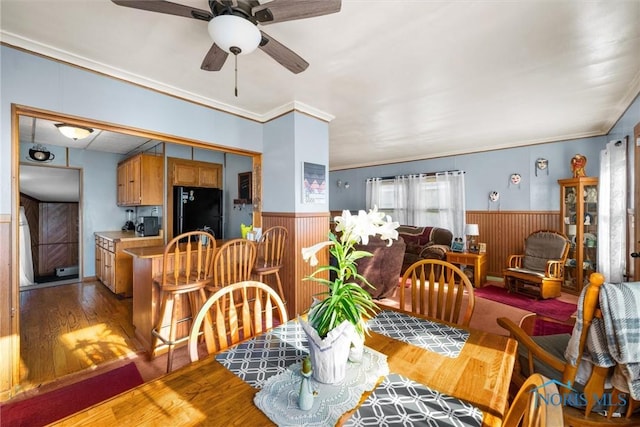 4532 290th St, Toledo, OH 43611 - dining room with a wainscoted wall, light wood-type flooring, a ceiling fan, ornamental molding, and wooden walls