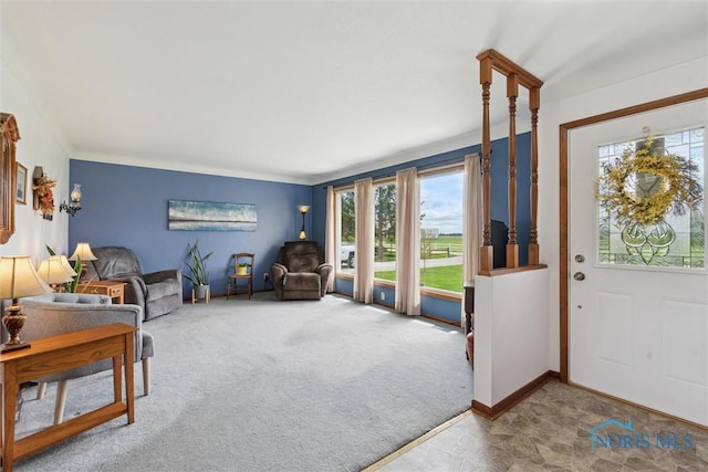 living room with a wealth of natural light, carpet, and baseboards