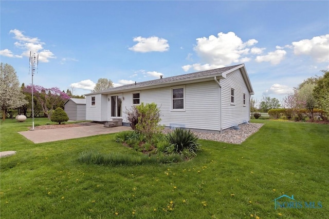 back of property with a patio, a lawn, and entry steps