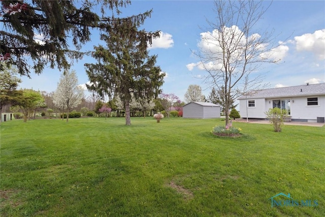 view of yard featuring a patio and central air condition unit