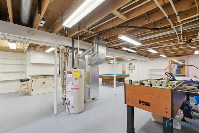 unfinished below grade area with gas water heater and billiards