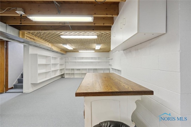 finished basement with stairs and carpet